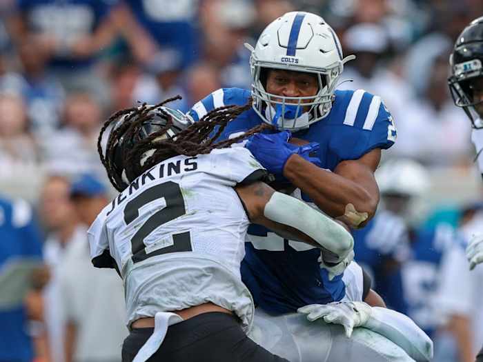 Jonathan Taylor is tackled by a Jaguars defender